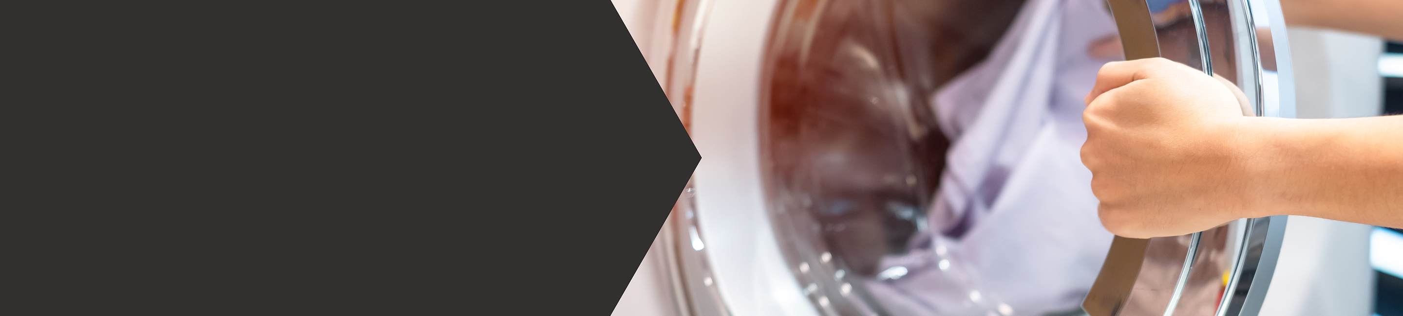 Close up of a hand opening a washing machine with white linin inside.